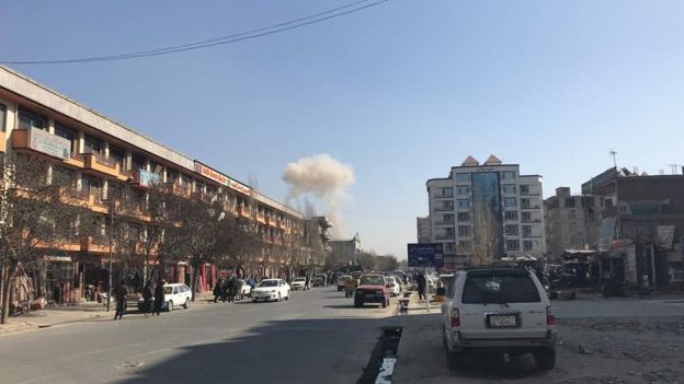 Kabul street with smoke in distance