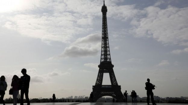 A soldier stands guard at the Eiffel Tower