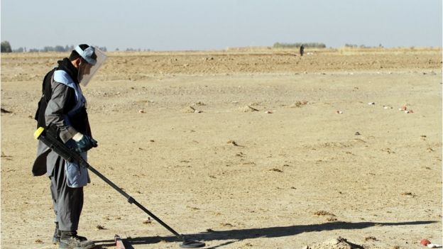 An Afghan de-miner searches for land mines in the Zhari district of Kandahar, Afghanistan on 9 January 2017