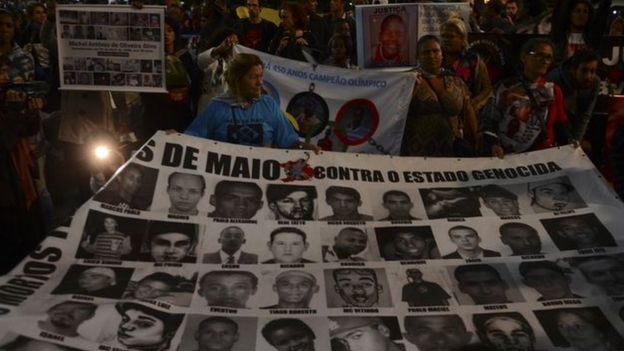 Protesto no centro de São Paulo com cartaz com rosto das vítimas