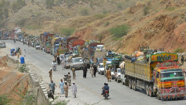 A line of vehicles are pictured as Pakistani civilians, fleeing a military operation in North Waziristan, wait to cross a checkpoint at the Bannu Frontier Region registration centre for internally displaced people in Saidgai on 22 June 2014