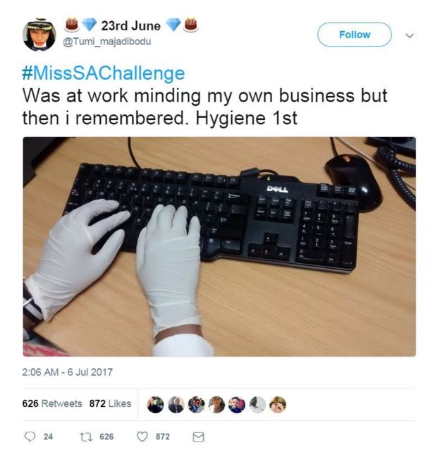 Person with latex gloves typing on computer keyboard saying hygiene first