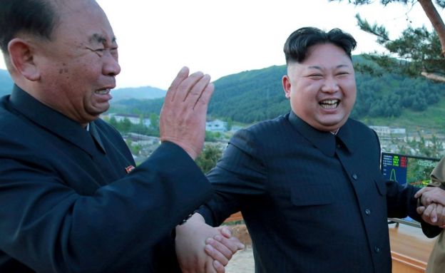 North Korean leader Kim Jong Un (R) reacts with Ri Pyong Chol (L) in this undated photo