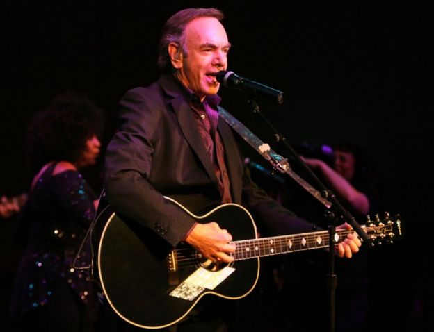 Neil Diamond pictured performing with a guitar in 2008