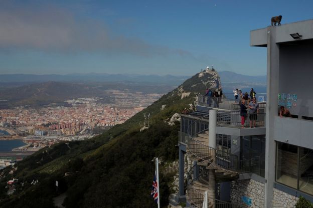 Tourists stand at a terrace on the top of the Rock in the British overseas territory of Gibraltar, historically claimed by Spain, 29 March