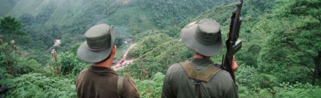 Undated picture of two armed Farc rebels monitoring the Berlin pass