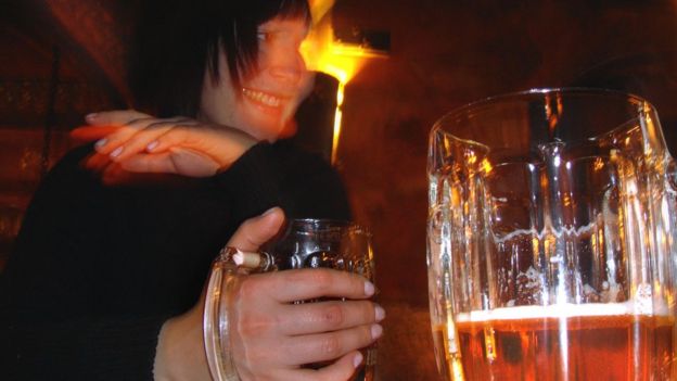 Woman drinking beer in a Moscow bar