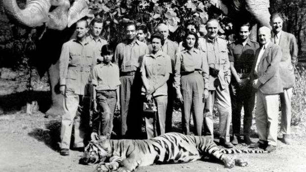 In this picture taken 26 January 1961 Britain's Queen Elizabeth (C) and Prince Philip (L) pose with the Maharaja (4L) and Maharani (5R) of Jaipur after a tiger shoot in Jaipur. The grandchildren of one of India's most famous former royals -- once one of the world's most beautiful women -- have dragged her to court demanding a share of the family fortune, a report said 28 July 2006