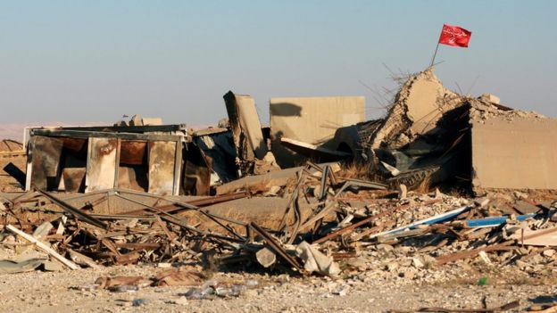 Shia religious flag is seen over a destroyed building inside Tal Afar military airport, Iraq (20 November 2016)