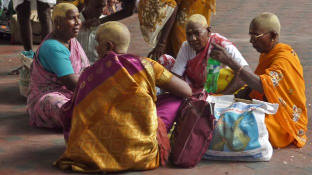 Women after their hair is shaved in a Hindu ceremony in India