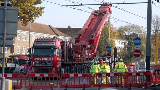 A crane is raised into position at the scene near the tram crash in Croydon,