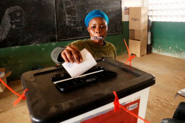 A woman casts her ballot during the presidential election at a polling station in Monrovia, Liberia, December 26, 2017.