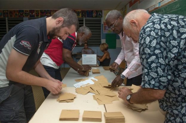 Election officials count votes at a polling station at Le Gosier elementary school in Poucet, on the French overseas territory of Guadeloupe, on 6 May, 2017,