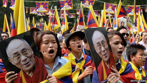 Tibetans in exile hold a picture of the Dalai Lama during a protest in New Delhi this year