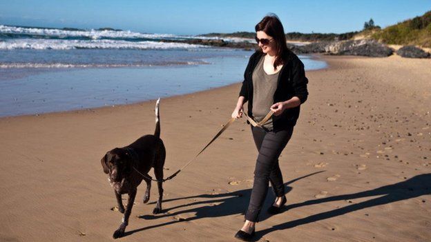 A Filtered Media employee walking her dog on a beach