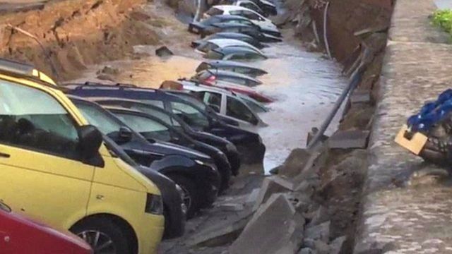 Cars in a sinkhole