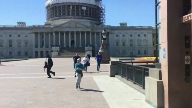 Capitol building, with people fleeing in the foreground