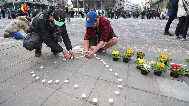 People put out candles and flowers in Brussels to pay tribute to the victims of the attacks.