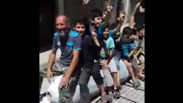 Children playing on a barrel bomb in Aleppo Syria