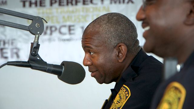Police officers attending a call-in radio programme