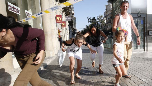 People leave a cordoned area on Las Ramblas, Barcelona