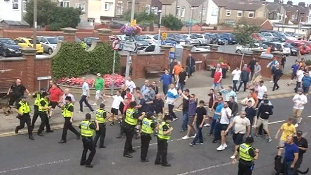Stand off between police and football fans