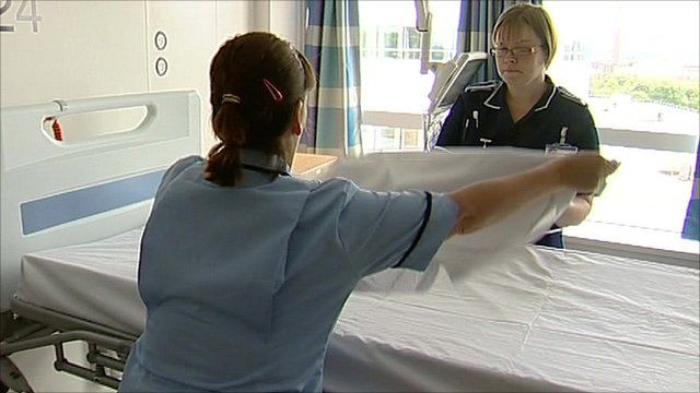 Nurse making a bed in a hospital