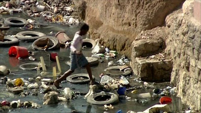 Child crossing infected stream in Haiti