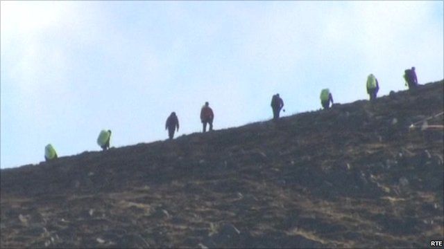 Recovery workers combing the mountains