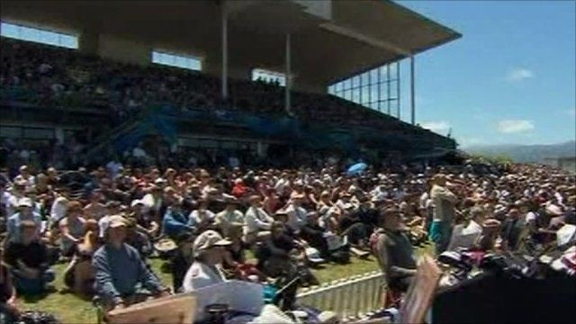 People marking two minutes' silence at the Omoto racecourse