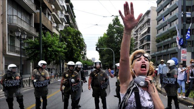 Protester and riot police
