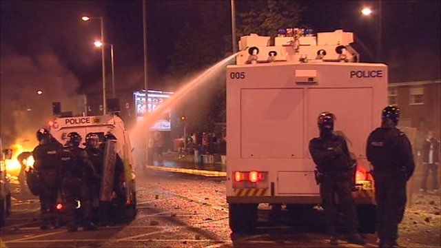 Police use a water cannon to disburse the crowd