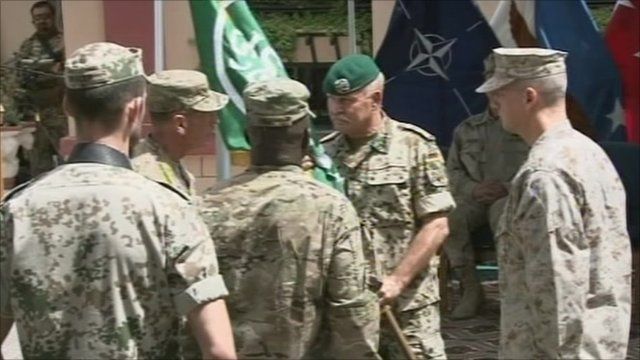Gen David Petraeus hands flag over to Gen John Allen