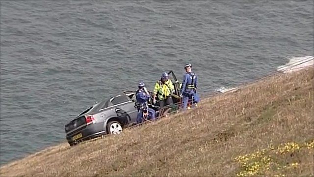 Rescuers pull the driver form the car at St Agnes Head