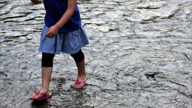 Anonymous girl paddles in river