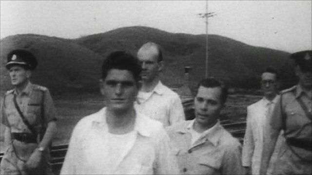 Three former POWs return
