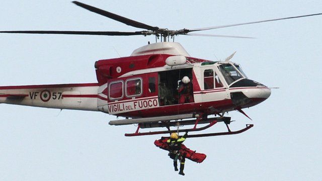 Crew member is winched into helicopter
