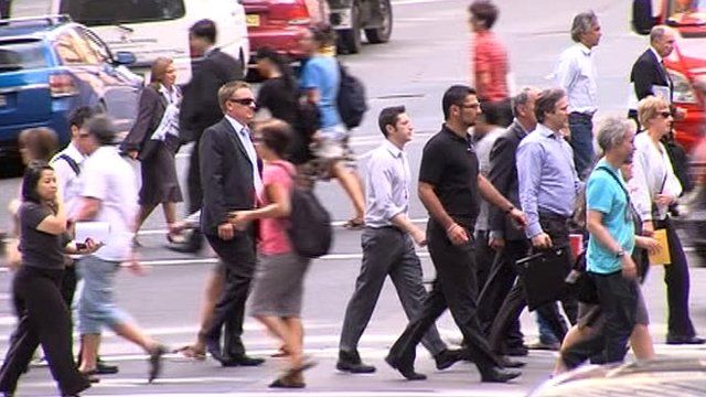 Commuters in Sydney crossing road
