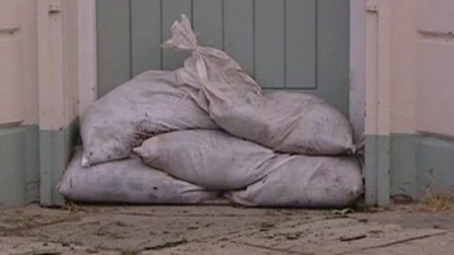 Sand bags protecting a house from flooding