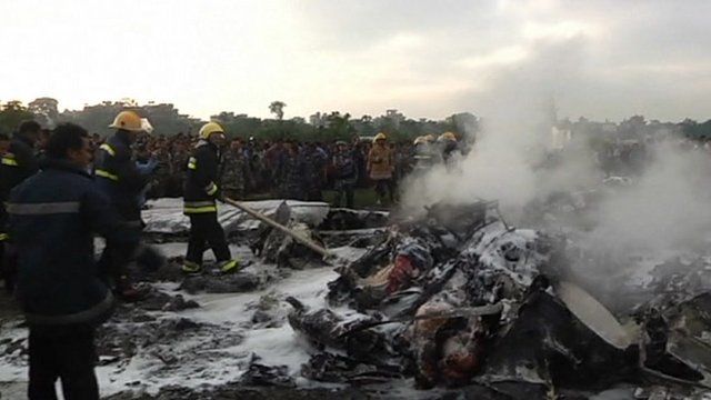 Kathmandu fire teams hosing down wreckage
