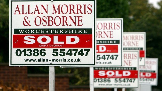 For sale boards outside houses