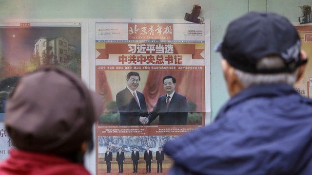 Chinese couple looking at newspaper