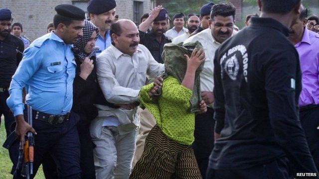 Security officials surrounding Rimsha