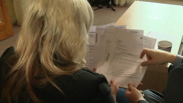 Woman looks at bills