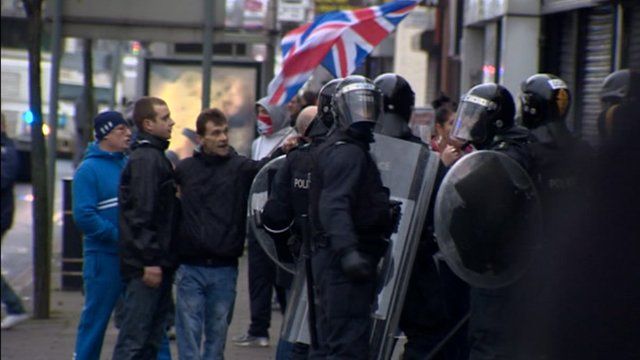 Riot police and protesters
