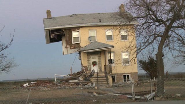 Damaged house bears Christmas wreath on Union Beach, New Jersey
