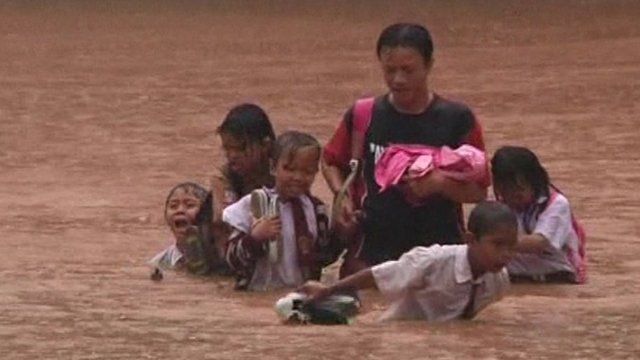People battling through floodwaters