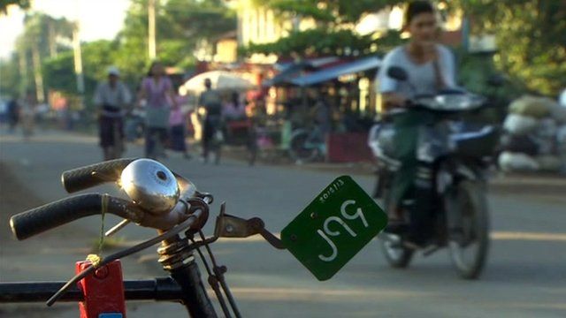 Motorbike and bicycles on a Burmese street