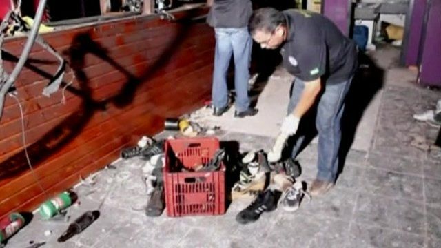 Officials sifting through the belongings those who were in the Kiss nightclub, Brazil