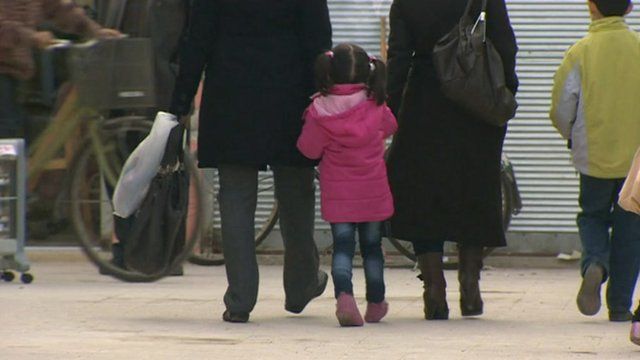 Family walking down street